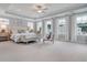 Spacious primary bedroom with tray ceilings and multiple windows, providing ample natural light at 110 Crosscut Ln, Summerville, SC 29486