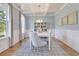 Inviting dining room with coffered ceilings, modern chandelier, and views of the backyard at 110 Crosscut Ln, Summerville, SC 29486