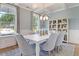 Bright dining room with a modern light fixture, natural light, and views of the backyard at 110 Crosscut Ln, Summerville, SC 29486