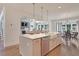 Bright kitchen with a large island, farmhouse sink, pendant lighting, and open to the living and dining areas at 110 Crosscut Ln, Summerville, SC 29486