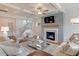 Inviting living room with fireplace, TV, plush seating, and coffered ceiling at 110 Crosscut Ln, Summerville, SC 29486