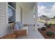 Comfortable front porch with view of neighborhood, landscaping, and bench seating at 110 Crosscut Ln, Summerville, SC 29486