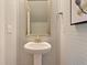 Cozy powder room features beadboard walls and a pedestal sink, creating a charming and functional space at 110 Crosscut Ln, Summerville, SC 29486