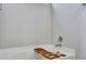 Relaxing white bathtub featuring a convenient wooden tray and modern chrome fixtures at 111 Pacolet St, Summerville, SC 29485