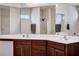Bathroom with wood vanity, double sinks, and large mirror at 111 Pacolet St, Summerville, SC 29485