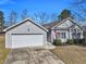 Inviting exterior view showcasing the home's architectural design and an attached two-car garage at 111 Pacolet St, Summerville, SC 29485