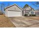 Home with a two-car garage. A wide concrete driveway is visible, and the lawn is tidy at 111 Pacolet St, Summerville, SC 29485