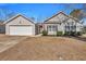 Traditional-style home exterior with a two-car garage, tidy landscaping, and a freshly mowed lawn at 111 Pacolet St, Summerville, SC 29485