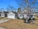 Exterior of home in a suburban neighborhood; the lawn is well-maintained, and a tree in the front provides shade at 111 Pacolet St, Summerville, SC 29485