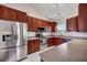 Well-lit kitchen with stainless steel appliances, light countertops, and wood cabinets at 111 Pacolet St, Summerville, SC 29485