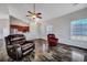 Open-concept living room with hardwood floors, a ceiling fan, and easy access to the kitchen, perfect for entertaining at 111 Pacolet St, Summerville, SC 29485
