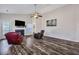 Stylish living room boasts hardwood floors, a fireplace, a ceiling fan, and a TV for entertainment at 111 Pacolet St, Summerville, SC 29485