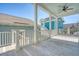 Outdoor space has wood plank flooring, ceiling fan, and railing overlooking neighborhood homes at 1118 John Mcenery Rd, Charleston, SC 29412