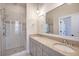 Beautiful bathroom features double vanity with granite countertop and walk-in shower with subway tile at 1118 John Mcenery Rd, Charleston, SC 29412