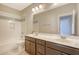 Bathroom with double sinks, a large mirror, a shower-tub combo, and ceramic tile flooring at 1118 John Mcenery Rd, Charleston, SC 29412