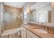 Lovely bathroom with double sinks, stone countertops, a walk-in shower, and attractive lighting at 1118 John Mcenery Rd, Charleston, SC 29412