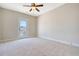 Bright bedroom featuring neutral walls, carpet flooring, a ceiling fan, and a glass door to a balcony at 1118 John Mcenery Rd, Charleston, SC 29412