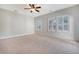 Spacious bedroom with carpet, shiplap accent wall, and ceiling fan; ample natural light at 1118 John Mcenery Rd, Charleston, SC 29412