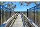 Picturesque boardwalk entrance with railings offering beautiful views of the marsh at 1118 John Mcenery Rd, Charleston, SC 29412