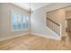 Well-lit dining room with hardwood floors, plantation shutters, and staircase access for elegant living at 1118 John Mcenery Rd, Charleston, SC 29412