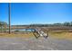 A dock on calm water under a cloudless sky with trees and vegetation in the background at 1118 John Mcenery Rd, Charleston, SC 29412