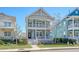 Charming two-story coastal home with double porches, light blue siding, and well-maintained landscaping at 1118 John Mcenery Rd, Charleston, SC 29412
