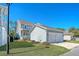 Side view of the house featuring light blue siding, a two car garage, and manicured lawn at 1118 John Mcenery Rd, Charleston, SC 29412