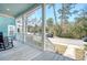 Inviting front porch with white railings and weathered wooden flooring offering relaxing views of the neighborhood at 1118 John Mcenery Rd, Charleston, SC 29412