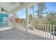 This covered porch has white railing overlooking the street and neighborhood at 1118 John Mcenery Rd, Charleston, SC 29412