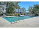 Sparkling community pool with clear blue water, surrounded by lounge chairs and lush landscaping at 1118 John Mcenery Rd, Charleston, SC 29412