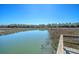 Marsh view on calm water under a cloudless sky with trees and vegetation in the background at 1118 John Mcenery Rd, Charleston, SC 29412