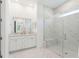 Modern bathroom boasts marble tiling, glass shower with bench, and dual sink vanity at 1140 Darling St, Summerville, SC 29485