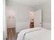 Well-lit bedroom offers wainscoting, wood floors, closet, and access to en-suite bathroom at 1140 Darling St, Summerville, SC 29485