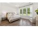 Tranquil bedroom with large windows, neutral tones, and stylish modern light fixture at 1140 Darling St, Summerville, SC 29485