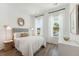 Inviting bedroom with stylish decor, wood floors, and natural light from large windows at 1140 Darling St, Summerville, SC 29485