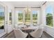Bright dining area with round table, modern chandelier, and large windows overlooking the greenery at 1140 Darling St, Summerville, SC 29485
