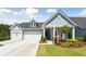 Charming single-Gathering home featuring a well-manicured lawn, a two car garage and welcoming curb appeal at 1140 Darling St, Summerville, SC 29485