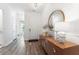 Elegant hallway with wood floors, a modern mirror, and decorative accents leading to other rooms at 1140 Darling St, Summerville, SC 29485