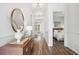 Inviting hallway with hardwood floors, stylish mirror, and console table leading to a bright bedroom at 1140 Darling St, Summerville, SC 29485