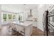 Well-lit kitchen with stainless steel appliances, quartz countertop island, and a dining area nearby at 1140 Darling St, Summerville, SC 29485