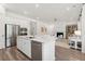 Open-concept kitchen with stainless steel appliances and quartz countertops, connecting to the living area at 1140 Darling St, Summerville, SC 29485