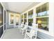 Covered front porch featuring rocking chairs, large windows, and inviting curb appeal at 1140 Darling St, Summerville, SC 29485
