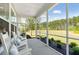 Screened porch with comfortable seating and a serene view of the wooded surroundings at 1140 Darling St, Summerville, SC 29485