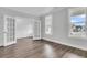 Bright living room with French doors, large windows, and wood-look flooring with white trim at 121 Grange Cir, Summerville, SC 29486