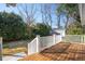 Inviting wooden back deck overlooks a private backyard with lush greenery and a storage shed at 1217 Bamboo Dr, Charleston, SC 29407