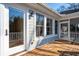 Inviting wooden back deck with access to the screen porch and home interior through glass doors at 1217 Bamboo Dr, Charleston, SC 29407