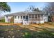 Back exterior of the property with a spacious screened in porch and a well-maintained yard at 1217 Bamboo Dr, Charleston, SC 29407
