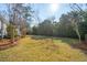Expansive backyard features lush greenery and mature trees, offering plenty of space for outdoor activities at 1217 Bamboo Dr, Charleston, SC 29407