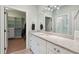 Bright bathroom featuring a granite countertop, dual sinks and access to a walk-in closet at 1217 Bamboo Dr, Charleston, SC 29407