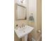 Compact half-bath with a pedestal sink, framed mirror and neutral decor at 1217 Bamboo Dr, Charleston, SC 29407